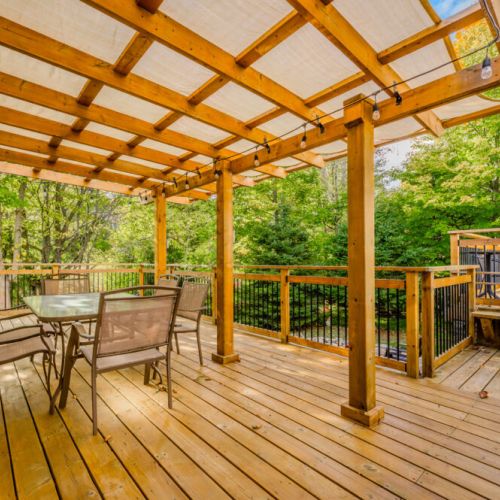 Step outside to our large, inviting deck where you can enjoy meals in the fresh air or simply relax under the wooden pergola.