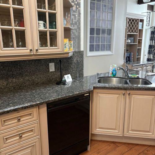 A spacious kitchen prep area with modern appliances and ample counter space. Perfect for home-style cooking during your cottage getaway.