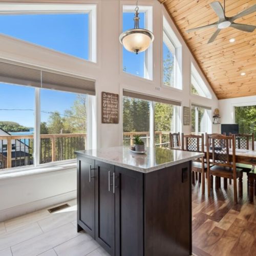 Large windows and warm wood finishes create an inviting atmosphere throughout the main living area.
