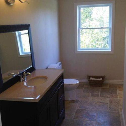 Enjoy the bright and roomy bathroom, complete with modern vanity and tranquil forest views — perfect for a relaxing travel retreat.
