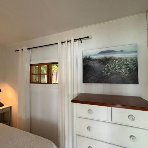 Extra storage and a peaceful, airy feel in the main bedroom.