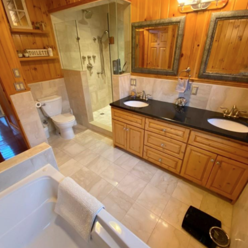 This spacious bathroom features dual sinks, a walk-in shower, and a soaking tub. It's the perfect place to unwind and recharge after a day of adventures.