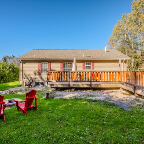 Gather around the fire pit in the spacious backyard or relax on the deck—perfect for evening conversations and outdoor meals with family and friends.