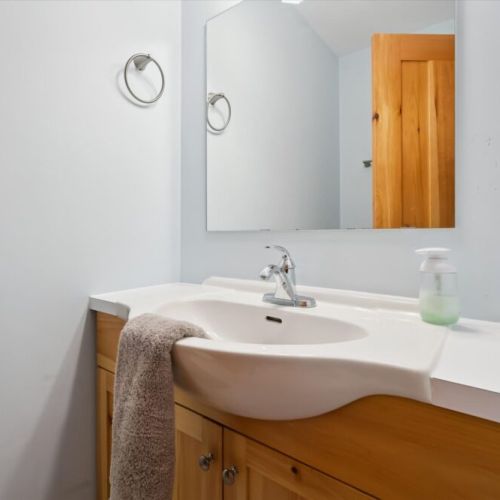 The clean and bright bathroom includes modern fixtures and cottage comforts for your stay.