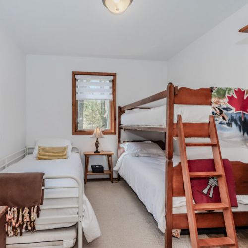 Charming bunk room ideal for kids and families, with comfortable beds and bright windows — a perfect addition to your family-friendly lakefront rental!