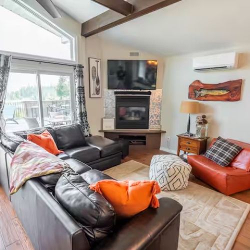 Gather with family and friends in the bright and inviting living room. With cozy leather seating, a gas fireplace, vaulted ceilings, and a large smart TV, this space is perfect for both relaxing evenings and lively movie nights.
