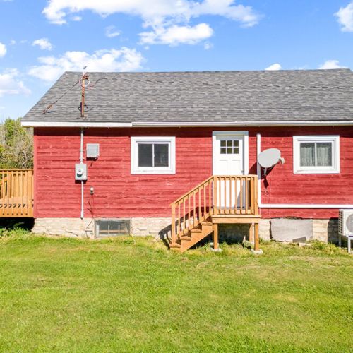 A charming country farmhouse surrounded by the quiet, natural landscape of the Bruce Peninsula.