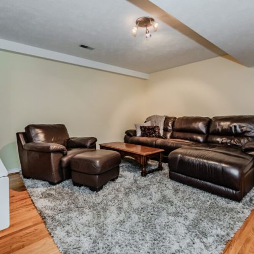 Comfortable lounge with leather recliners, cozy rug, and soft lighting—ideal for relaxed evenings and casual conversation.
