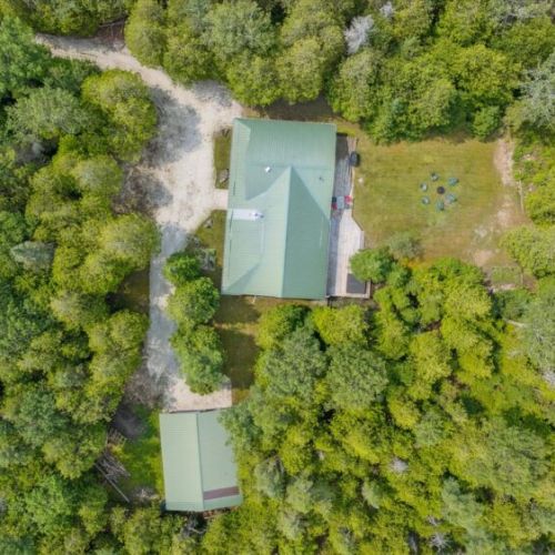 An overhead view of the main cottage and detached garage, with plenty of outdoor space for year-round fun.