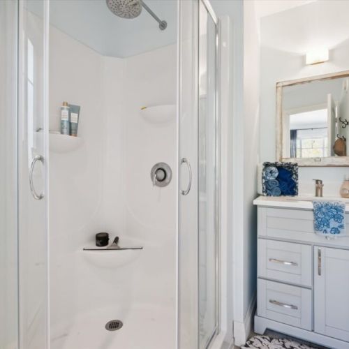 Freshen up in the clean, modern bathroom featuring a walk-in shower and everything you need for a comfortable stay.