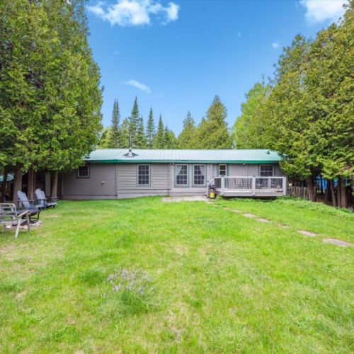The quiet backyard garden stretches out behind the home, offering space to roam, play, and relax. Shaded seating nooks and lush greenery make this a true retreat.