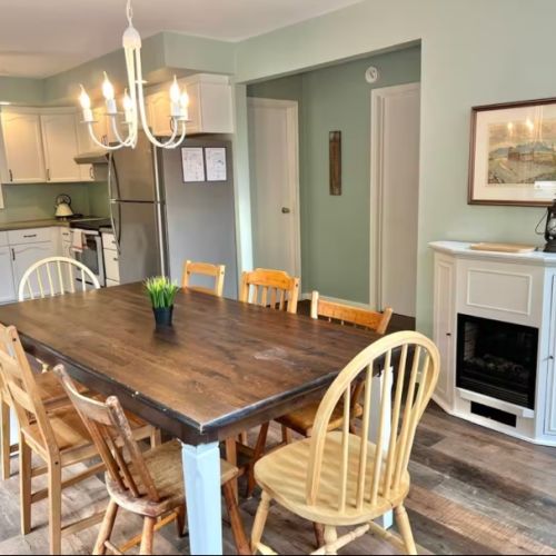 Gather around the spacious dining table for family meals or game nights. The open-concept design lets in natural light and connects seamlessly to the living room and outdoor deck.