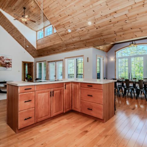 Open-concept kitchen with island and vaulted ceilings—perfect for group getaways, family vacations, or relaxing retreats in nature.