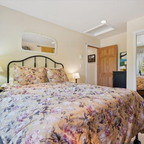 Another inviting bedroom offers a peaceful space to unwind, with soft natural light and comfortable furnishings.
