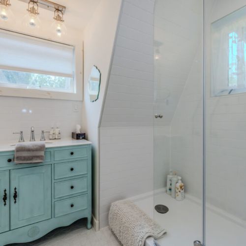 Bright, spa-like full bathroom featuring a deep tub, rain shower, and stylish vanity—perfect for winding down after a day of adventure.