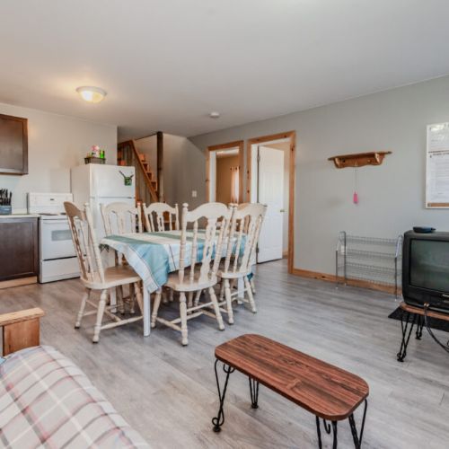A fully equipped kitchen connects seamlessly with the dining area, making meal prep and dining a breeze.