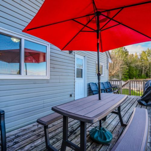 Equipped with a picnic table and BBQ grill, the deck is ready for family cookouts and gatherings.