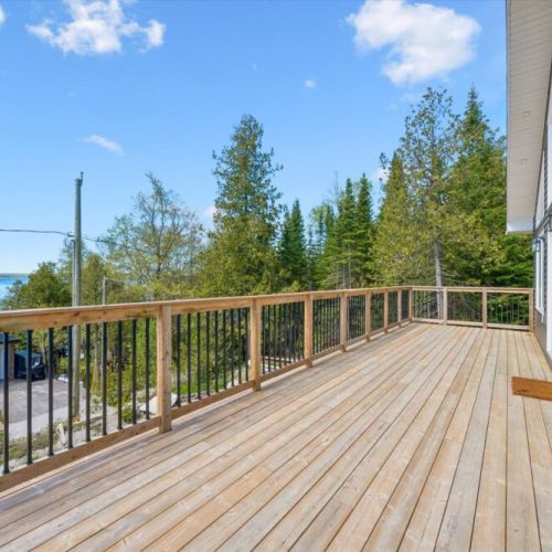 The spacious upper deck offers plenty of room for outdoor dining, relaxing, and taking in the surrounding scenery.