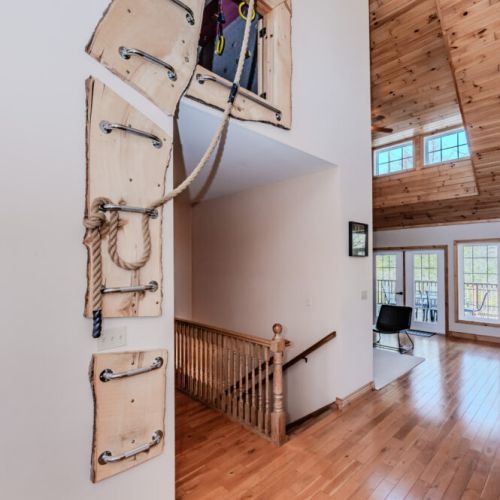 Adventure starts indoors with this unique rope-and-ladder access to a hidden climbing loft—perfect for active families, fitness enthusiasts, or kids seeking indoor fun during a nature escape.