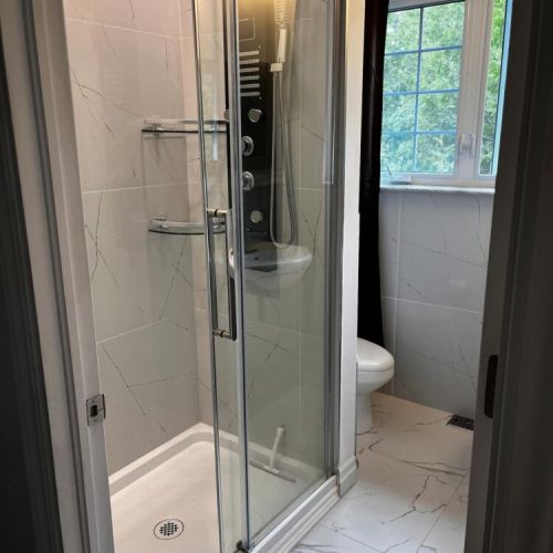 Clean, modern bathroom with walk-in shower and fresh finishes
