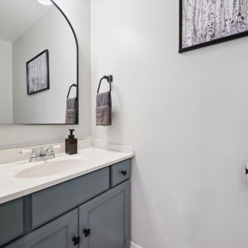 Convenient powder room with modern finishes and cottage-inspired style.