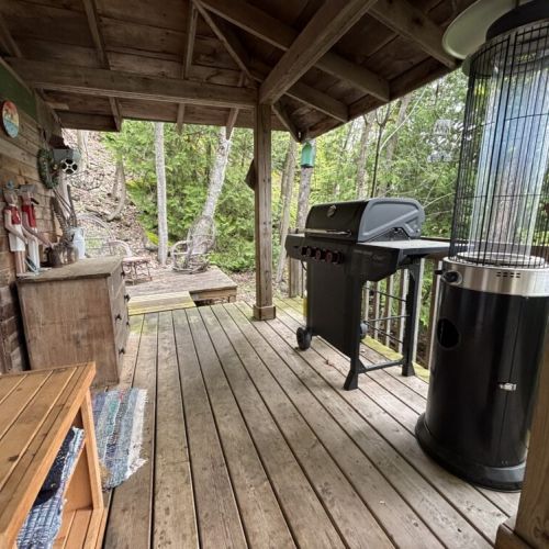 Outdoor heater and BBQ setup on the covered porch—ideal for cool evenings and lakeside meals.