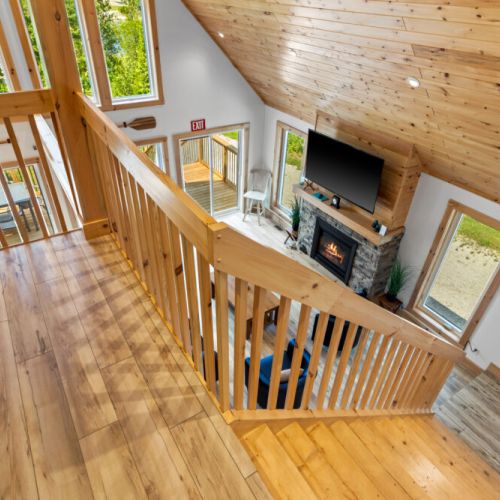 The loft overlooks the great room, showcasing the cottage's bright and spacious design.