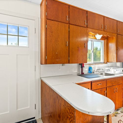 The kitchen offers generous counter space and plenty of cabinetry for easy meal preparation during your stay.