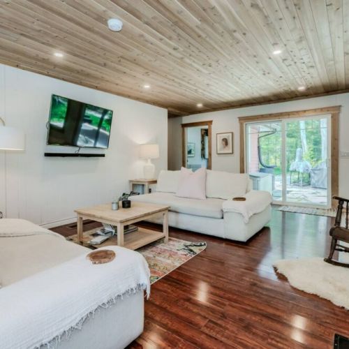Gather by the stone fireplace in the Great Room. Sink into plush couches surrounded by natural wood finishes and cozy ambiance.