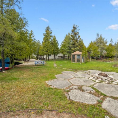 A large outdoor area offers plenty of room to play, relax, and enjoy time together by the lake.