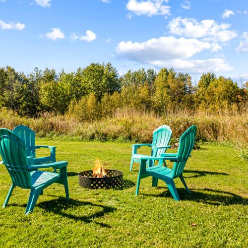 Gather around the outdoor firepit in Adirondack chairs for relaxing evenings under the stars.