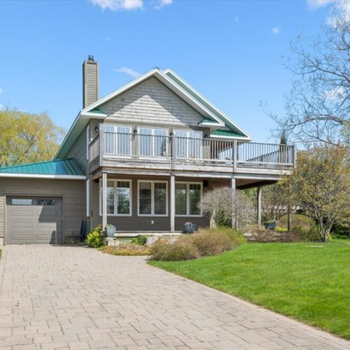 Welcoming front exterior with private driveway and spacious outdoor living areas.