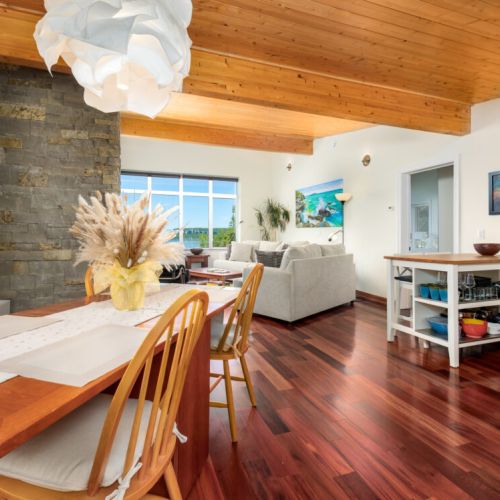 The open-concept layout seamlessly connects the dining area, kitchen, and lakeview living room.