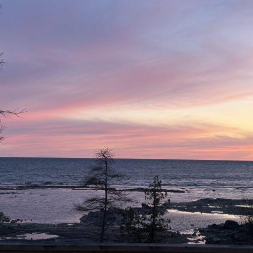 Enjoy peaceful evenings on the waterfront with pastel skies stretching endlessly over crystal-clear waters.