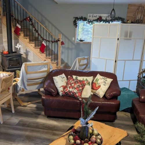 Warm and festive living room with cozy seating and holiday décor—perfect for celebrating the season in comfort and style.