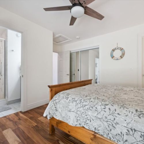 Wake up refreshed in the bright primary suite featuring a private ensuite bathroom and relaxing natural surroundings.
