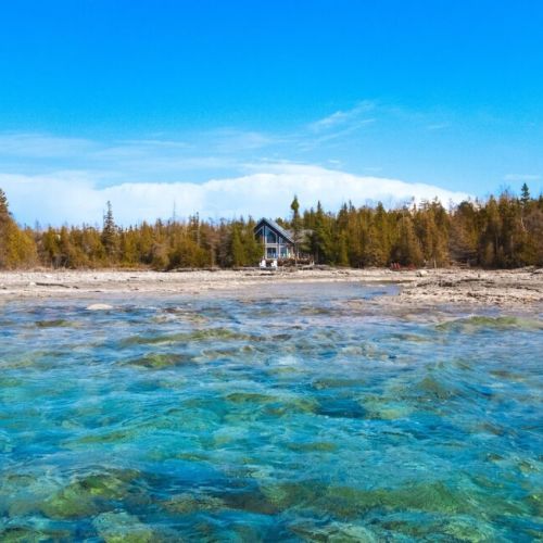 A breathtaking backdrop—modern lakehouse framed by natural beauty.