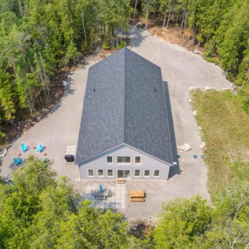 Wanderwood’s private lot is bordered by trees, with outdoor seating areas and space to explore.
