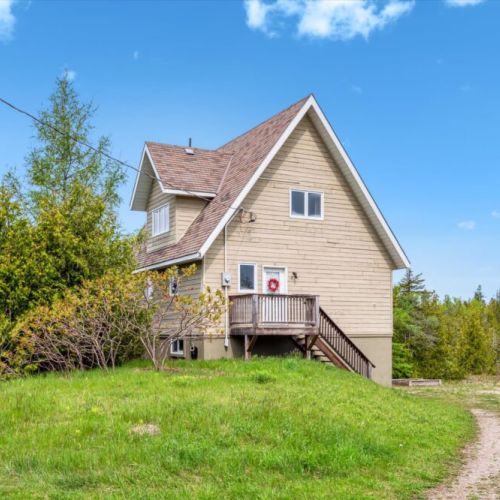 This charming A-frame cottage greets you with rustic cedar siding and a peaceful, wooded setting—your perfect retreat awaits.