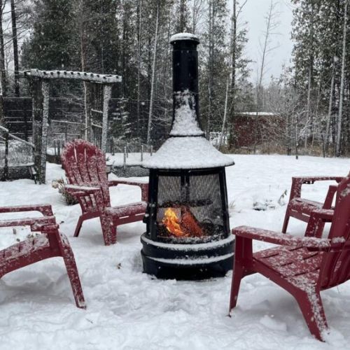 Gather around the outdoor fire table, wrapped in blankets, while snowflakes fall and the forest goes quiet.
