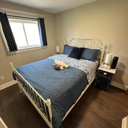 The second bedroom boasts a bright and airy ambiance with a queen-sized bed, creating a serene and inviting space for relaxation and rejuvenation.