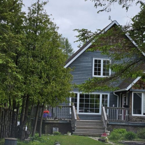 Welcome to 3 Bears Cottage – Your cozy lakeside retreat nestled among the trees, with a spacious deck for morning coffee or evening drinks.