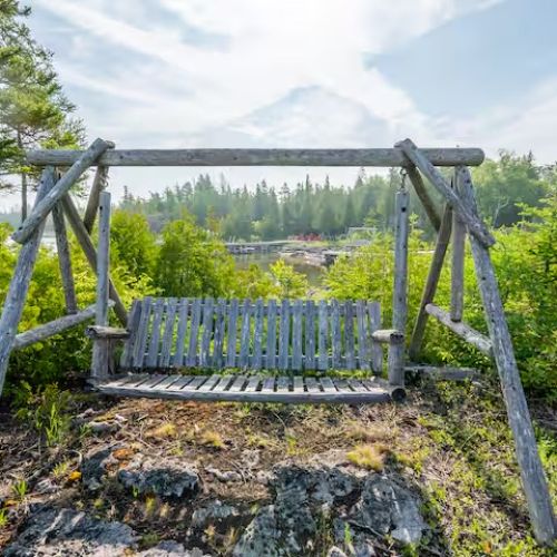 Rustic wooden swing with sweeping views of the shoreline — a quiet, romantic place to watch the sunset.