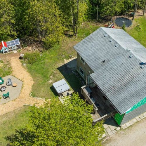 Enjoy the private backyard featuring a hot tub, fire pit area, and plenty of outdoor space to gather, unwind, and make lasting memories.