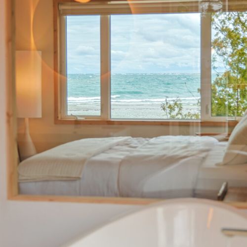 Indulge in the ultimate lakefront luxury with this spacious bedroom. The en-suite bathroom offers stunning lake views, adding a touch of tranquility to your morning routine.