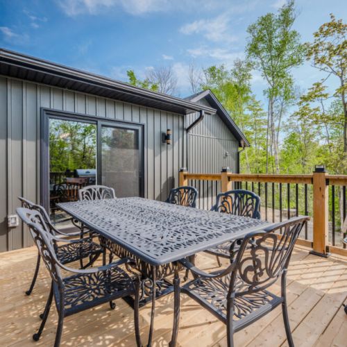 Cozy seating area on the deck, perfect for relaxing and taking in the natural surroundings. The deck offers plenty of space for outdoor activities and relaxation.