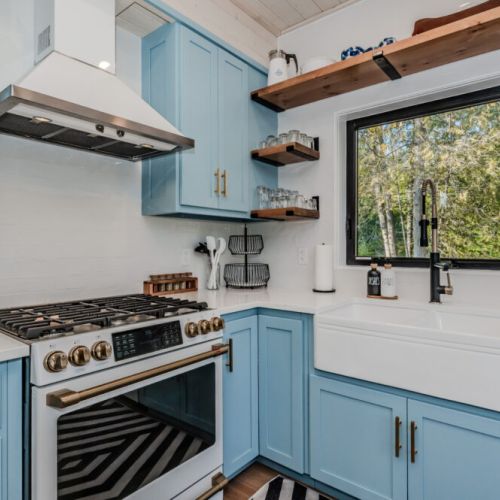 Charming vacation rental kitchen with modern appliances, farmhouse sink, and picture-perfect views—ideal for cozy getaways and lakeside escapes. Cook, unwind, and enjoy your dream stay!
