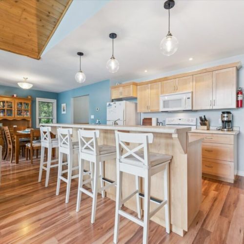 Spacious kitchen with breakfast bar seating for four, perfect for casual meals and conversation.