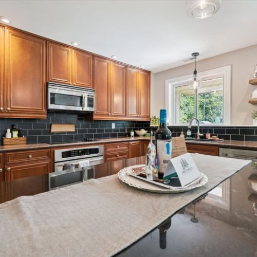 Fully equipped kitchen with large island and seating, ideal for cooking and socializing.