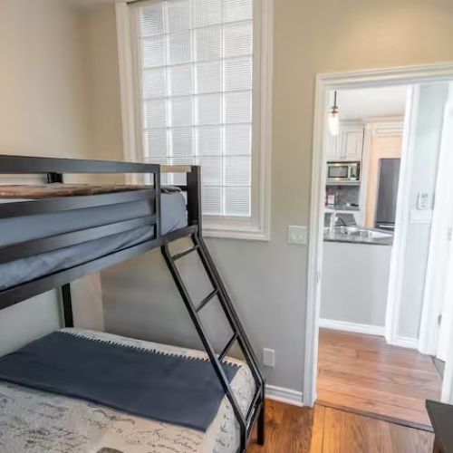 The bunk room opens conveniently into the main living area, making it easy for families to stay connected.